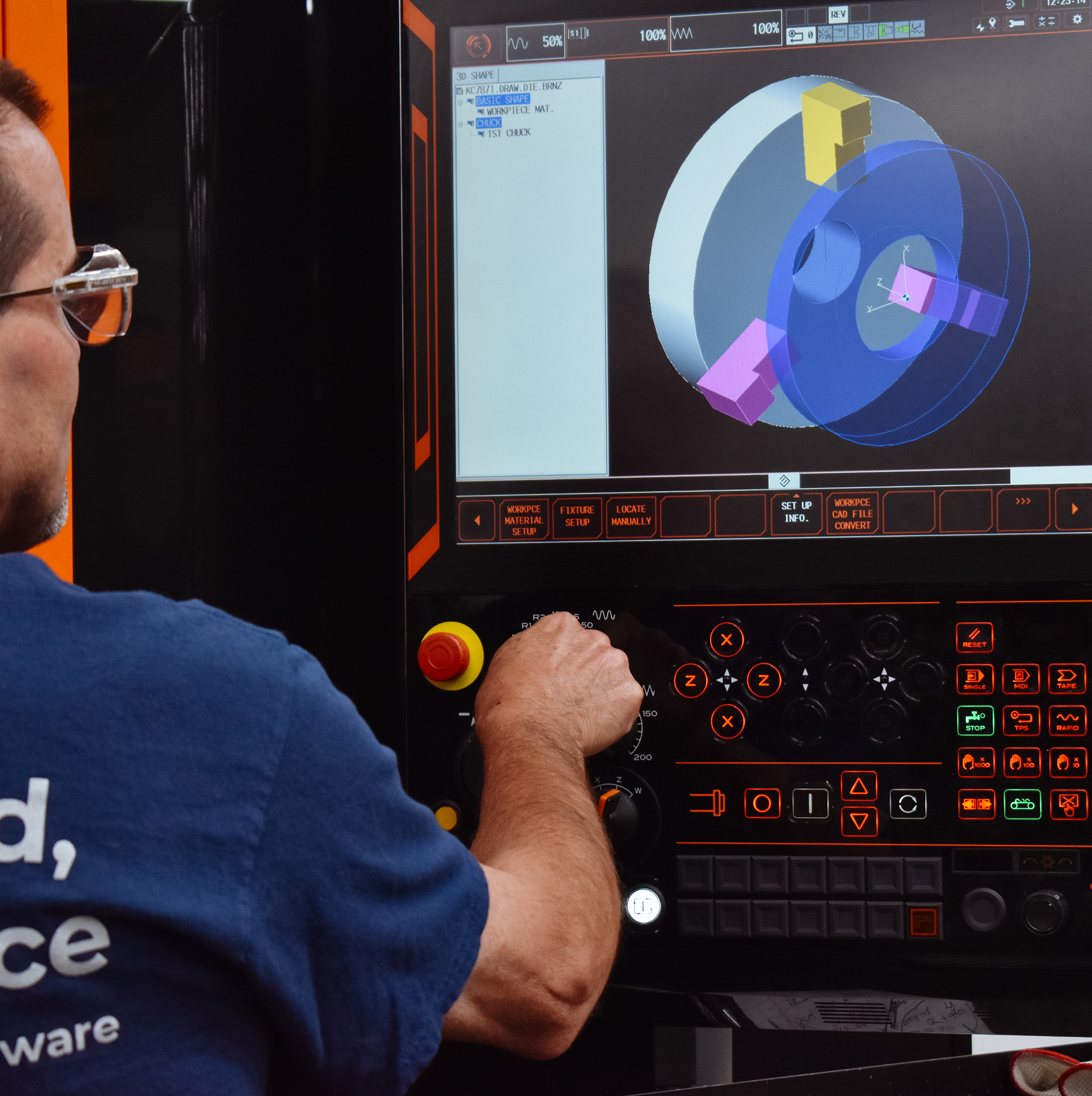 SynergyOps employee reviewing CAAD specs on a machine